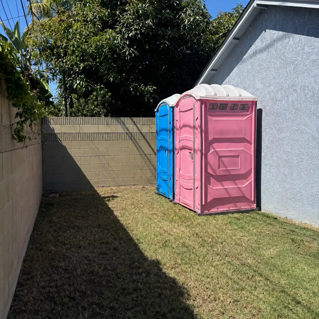 Porta potties placed in a side yard of a home