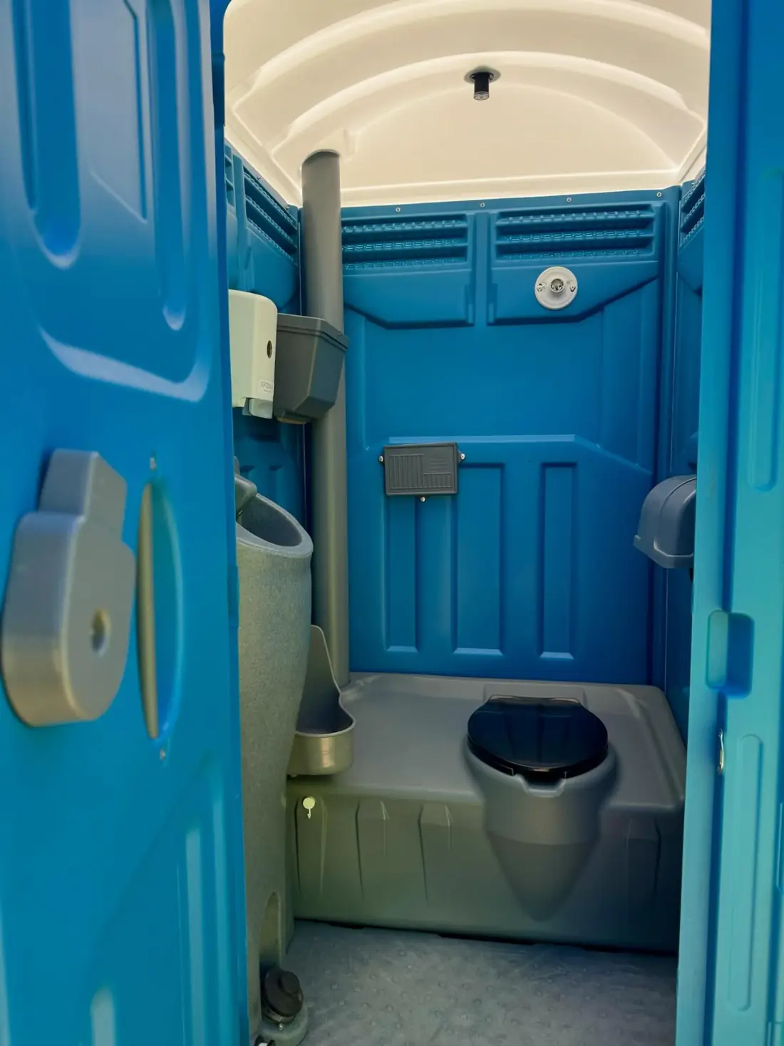 Inside a clean porta potty with hand sanitizer from Clean Sanitation Pros, available for delivery to Weed, NM