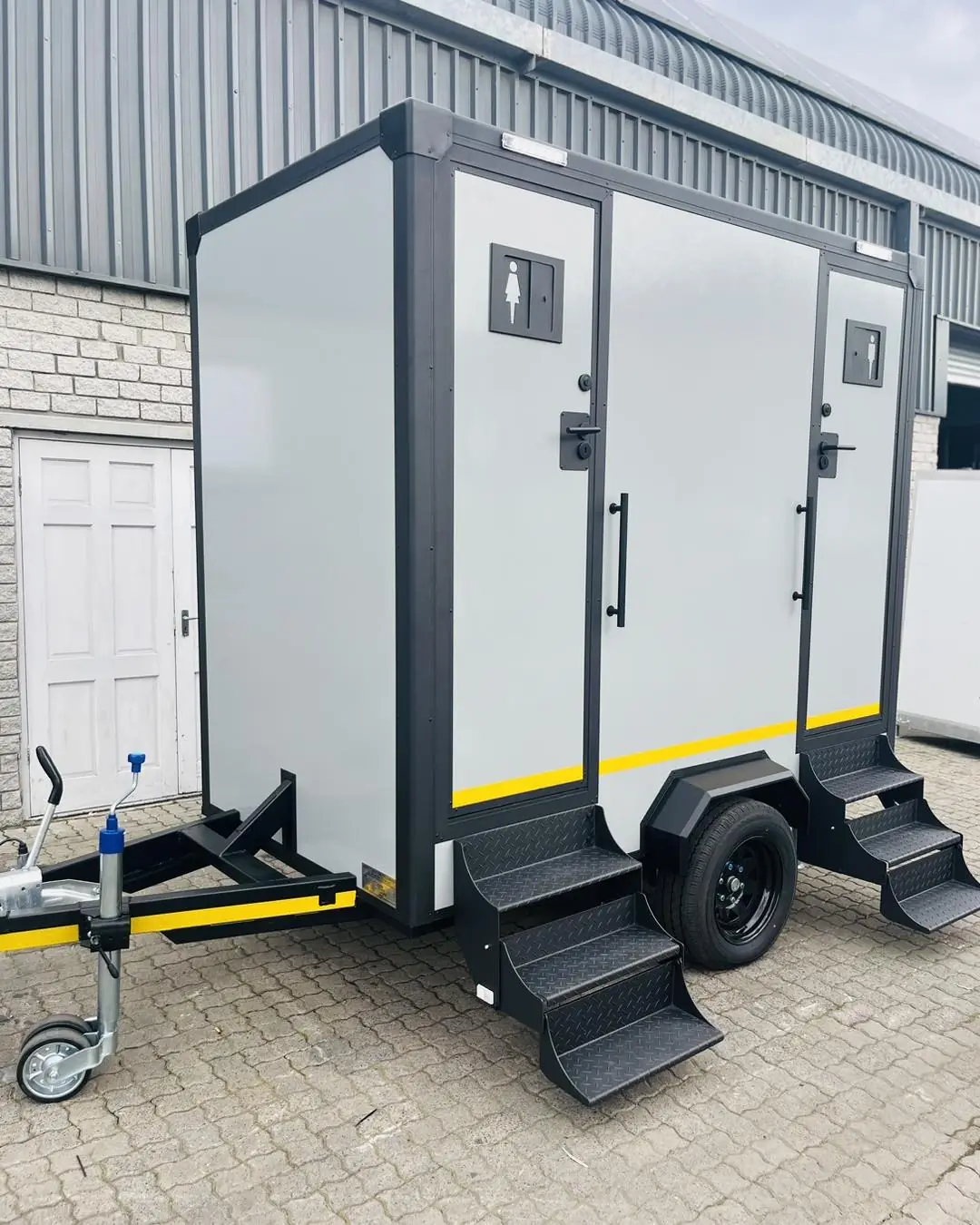 A two-door restroom trailer from Clean Sanitation Pros, available for delivery to Cloudcroft, NM